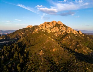 Fototapeta premium Picturesque mountain range with lush greenery and rugged rock formations scenery