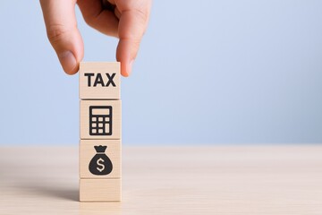 Taxation Concept with Wooden Blocks: Finance, Accounting, and Investment Strategy for Financial Planning