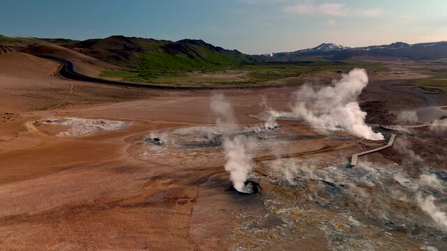 Witness the breathtaking geothermal activity in Iceland, where steam rises from the earth and creates a mesmerizing display against the stark landscape. Hverir Myvatn