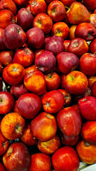 An abundant pile of fresh apples. Fruits on a market stall. Eco food, vegetarian lifestyle, organic nutrition, and healthy eating.