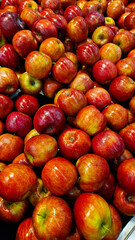 An abundant pile of fresh apples. Fruits on a market stall. Eco food, vegetarian lifestyle, organic nutrition, and healthy eating.