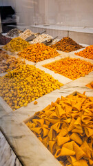 A variety of nuts and dried fruits displayed on a market stall.  Eco food, vegetarian diet, organic snacks, and healthy natural nutrition.