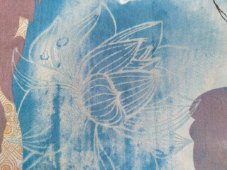 Batik fabric with floral motifs in brown outlines over a geometric beige pattern, blending traditional and modern design elements beautifully.