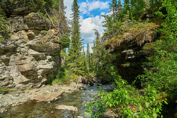 beautiful waterfall flowing into a rocky gorge.