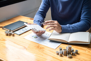 Young man and pile coins to planning growing saving strategy with pile coins for future plan fund of travel, education, home and retirement