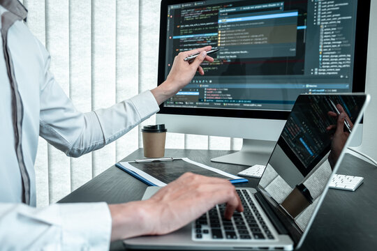 Young Programmer working in software javascript computer in IT office, Writing codes and data code website and coding database technologies to find solution to problem