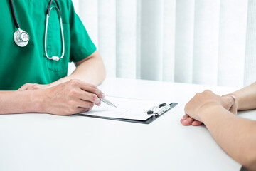 Doctor presenting with the patient and checking results on report and prescription about the...