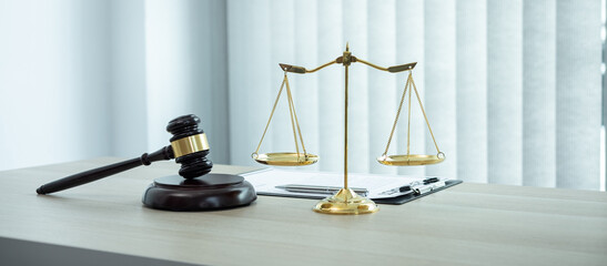 Judge gavel with Justice at law firm in background with legal case document contract, law and justice, attorney, lawsuit