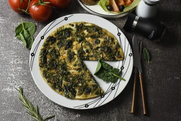 Image of omlette with young spinach.