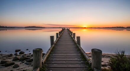 Fototapeta premium Serene Sunset Over Wooden Pier on Calm Water.