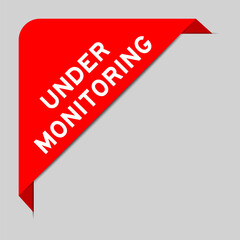 Red color of corner label banner with word under monitoring on gray background