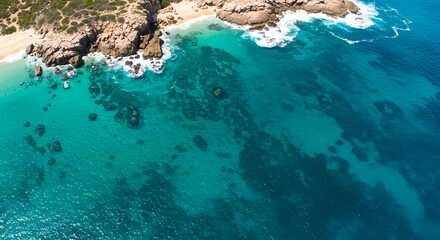 Aerial View: Turquoise Ocean Waves Crashing on Rocky Coastline - Tropical Beach Paradise