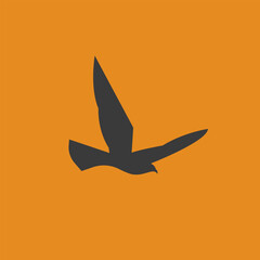 Silhouette of an eagle flying with wings spread wide on an orange background. Minimalist black eagle in flight.