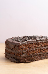 Indulge in a slice of rich, moist chocolate cake, covered in decadent chocolate sprinkles, a sweet treat for any occasion