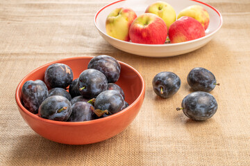 Sweet black plum on jute cloth, macro.