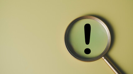 Warning and alert concept with magnifying glass highlighting black exclamation mark on plain background, symbolizing caution, important notice, risk awareness, and critical business message.