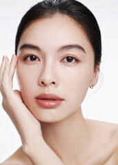 Close-up portrait of a young woman showcasing natural beauty and subtle makeup.