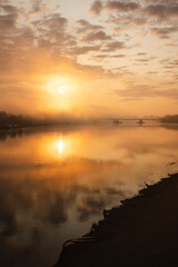 sunrise over the foggy river in Toruń