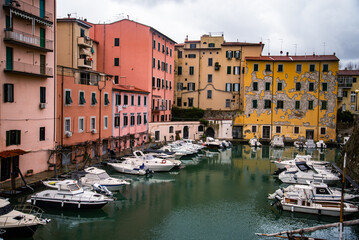 A canal so called "fossi with moored boats in the Venezia Nuova, Livorno, Italy