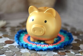 Cute nice lovely piggy bank golden on the crocheted doily cozy photo 