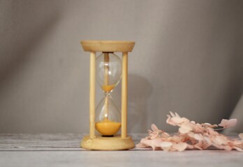 Hourglass sandglass and flowers time symbol pass photo 