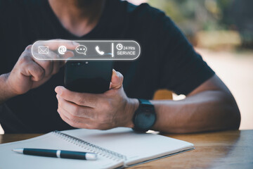 24-7 customer service support concept. Businessman hands holding digital contact icons, including email, phone, and chat, representing communication, accessibility, and online business care.