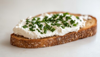 Close-Up Low Angle View Of A Delicious Serving Of Healthy Low-Fat Cream Cheese And Chopped Chives On Freshly Baked Rye Bread