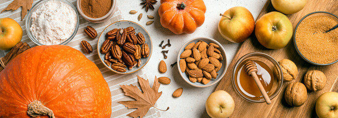 Autumn fall baking background with pumpkins, apples, nuts, food ingredients