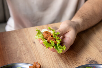 Making raw meatballs ( Turkish: Cig Kofte ) on wooden background	