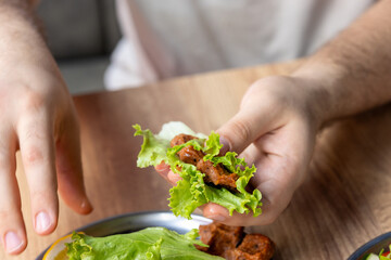 Making raw meatballs ( Turkish: Cig Kofte ) on wooden background	
