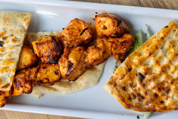 turkish local food Grilled chicken pieces with flatbread on a plate