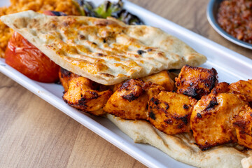 turkish local food Grilled chicken pieces with flatbread on a plate