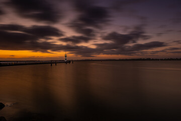 Beautiful sunrise at the lighthouse on Timmendorfer Strand.