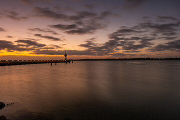 Beautiful sunrise at the lighthouse on Timmendorfer Strand.