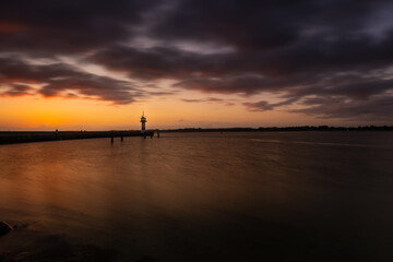 Beautiful sunrise at the lighthouse on Timmendorfer Strand.