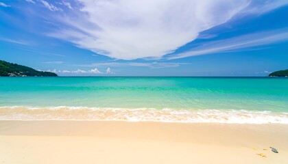 Serene turquoise ocean waves gently lapping at a pristine white sand beach under a vibrant blue sky.
