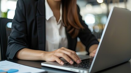 woman working with finances on laptop