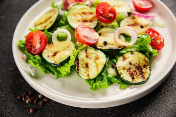 Salad grilled zucchini, tomato, lettuce tasty snack fresh delicious gourmet food background on the table rustic food top view copy space keto and paleo diet vegan and vegetarian food