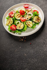 Salad grilled zucchini, tomato, lettuce tasty snack fresh delicious gourmet food background on the table rustic food top view copy space keto and paleo diet vegan and vegetarian food