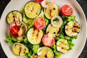 Salad grilled zucchini, tomato, lettuce tasty snack fresh delicious gourmet food background on the table rustic food top view copy space keto and paleo diet vegan and vegetarian food