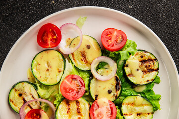 Salad grilled zucchini, tomato, lettuce tasty snack fresh delicious gourmet food background on the table rustic food top view copy space keto and paleo diet vegan and vegetarian food