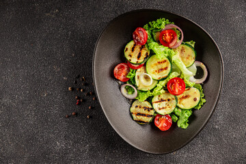 Salad grilled zucchini, tomato, lettuce tasty snack fresh delicious gourmet food background on the...