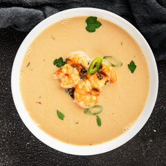 Tom kha soup shrimp, coconut milk, miso paste tasty seafood snack fresh delicious gourmet food background on the table rustic food top view copy space pescetarian diet
