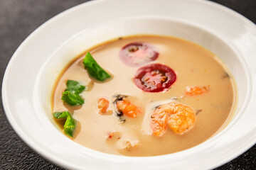 Tom kha soup shrimp, coconut milk, miso paste tasty seafood snack fresh delicious gourmet food background on the table rustic food top view copy space pescetarian diet