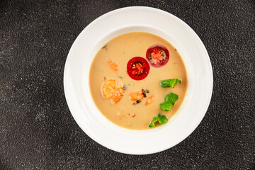 Tom kha soup shrimp, coconut milk, miso paste tasty seafood snack fresh delicious gourmet food background on the table rustic food top view copy space pescetarian diet