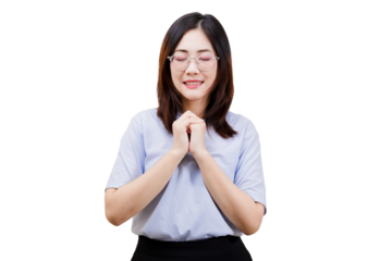 A woman with glasses is standing with her hands clasped together, expressing a gesture of prayer or gratitude.