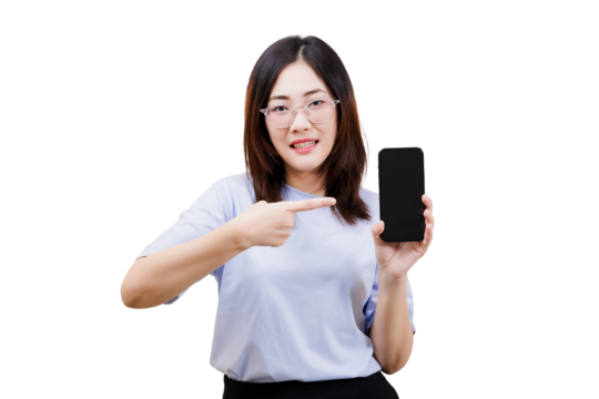 A woman wearing glasses points to a smartphone, showcasing its screen with a smile.