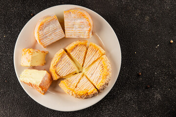 Cheese plate camembert, brie, munster french cheese tasty snack fresh delicious gourmet food background on the table rustic food top view copy space