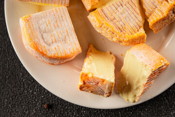 Cheese plate camembert, brie, munster french cheese tasty snack fresh delicious gourmet food background on the table rustic food top view copy space