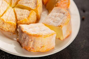 Cheese plate camembert, brie, munster french cheese tasty snack fresh delicious gourmet food background on the table rustic food top view copy space